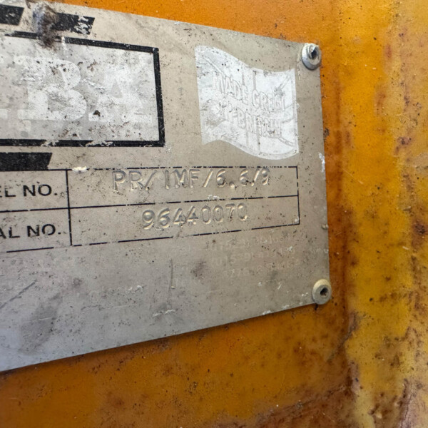 Weathered metal identification plate on an orange metal background; fields for MODEL NO. and SERIAL NO. with faded numbers visible and screws in corners.