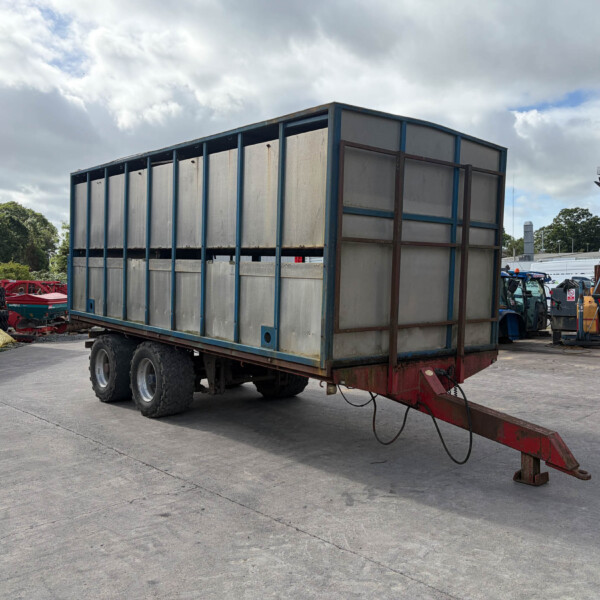 Large metal-sided freight trailer on a wheeled trailer in an industrial yard