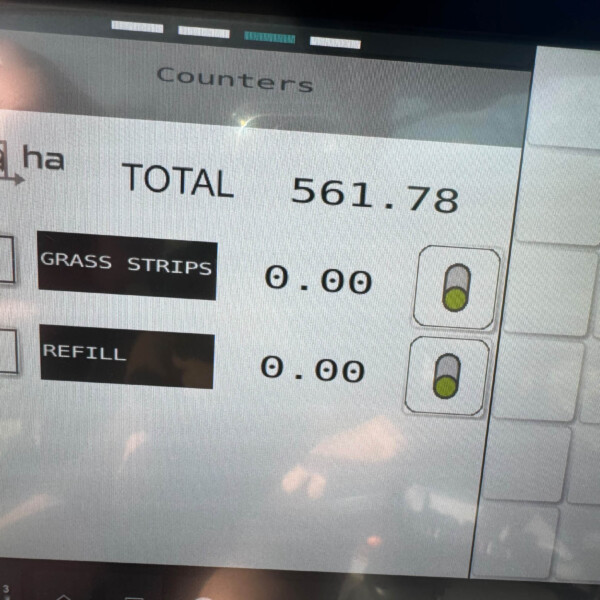 Touchscreen display showing a running total of 561.78 with a Grass Strips option on the left panel and measurement icons on the right.