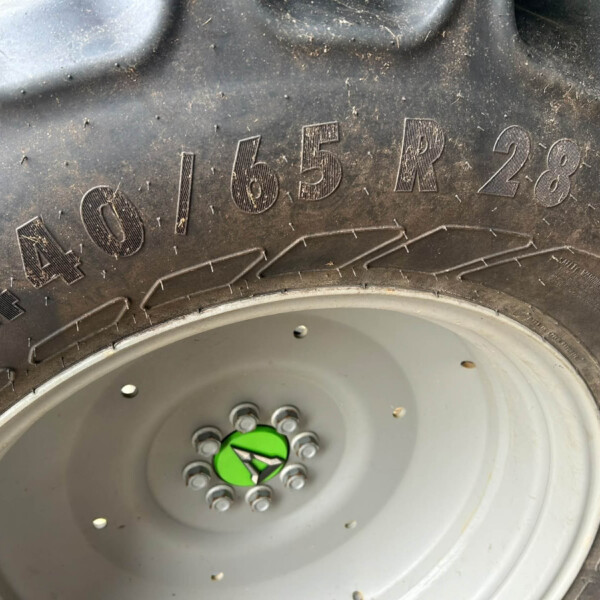 Close-up of a dirty off-road tire showing the embossed '4x4' and wheel with lug nuts.