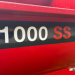 Close-up of a red surface with white '1000 SS' lettering on a dark stripe.