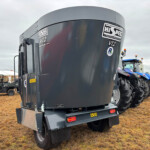 Close-up of a large gray truck trailer with Hi-Spec stickers, chains, and mudguards at an outdoor show ground.