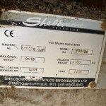 Close-up of a dusty metal nameplate on a machine, showing the brand Shelbourne Reynolds Engineering Ltd and serial/weight numbers.