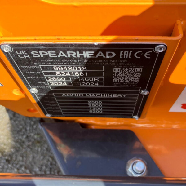 Close-up of a black identification plate on an orange Spearhead agricultural machine, listing model 9948018, serial S241681, weight 2690 kg, year 2024.
