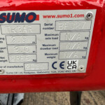 Metal identification plate on a red machine showing SumO branding, model TR3AR, serial BF327, width 2.9 m, transport width 3.0 m, net weight 2855 kg, manufactured 2026.