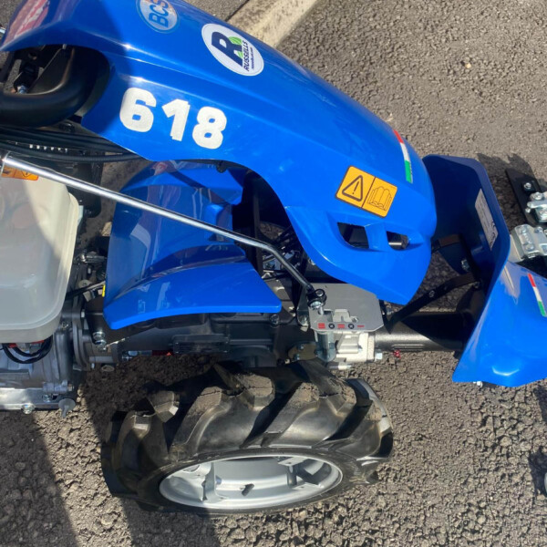 Blue ride-on lawn tractor with the number 618 on the side, viewed from above.