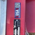 Sticker on a red metal surface showing a QR code and 'BUILT IN THE USA' branding with product support text nearby.